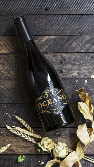 Oceano wine bottle laying in grass